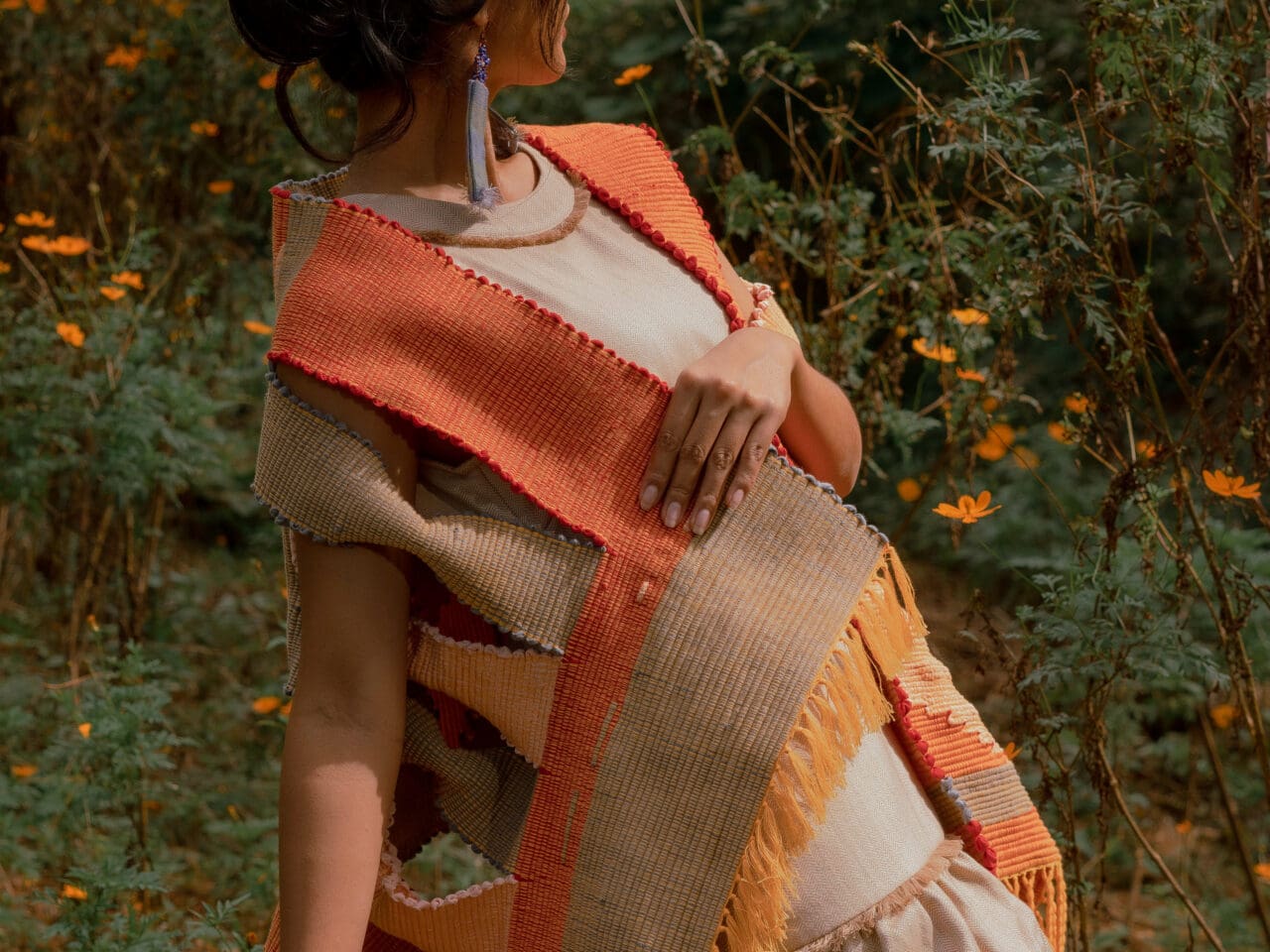 a woman wearing an orange BAYO atalier local handcrafted garment