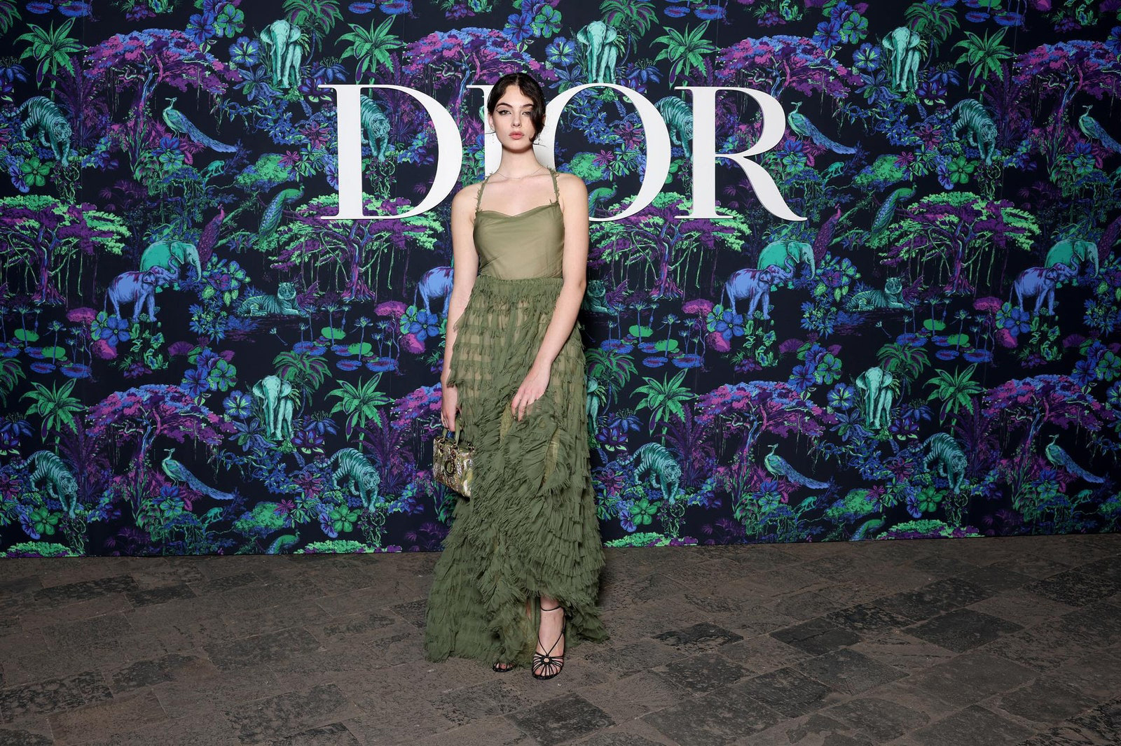 Dior Fall/Winter 2023 Show In Mumbai Deva Cassel wore a Dior Spring-Summer 2023 green silk dress with a Dior bag and shoes.