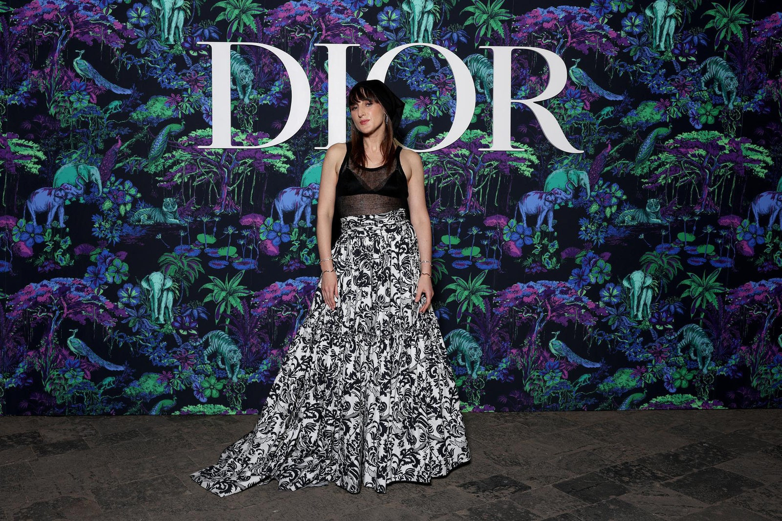Dior Fall/Winter 2023 Show In Mumbai Juliette Armanet wore a Dior Cruise 2023 black knit top with a printed black and white silk crepe skirt.