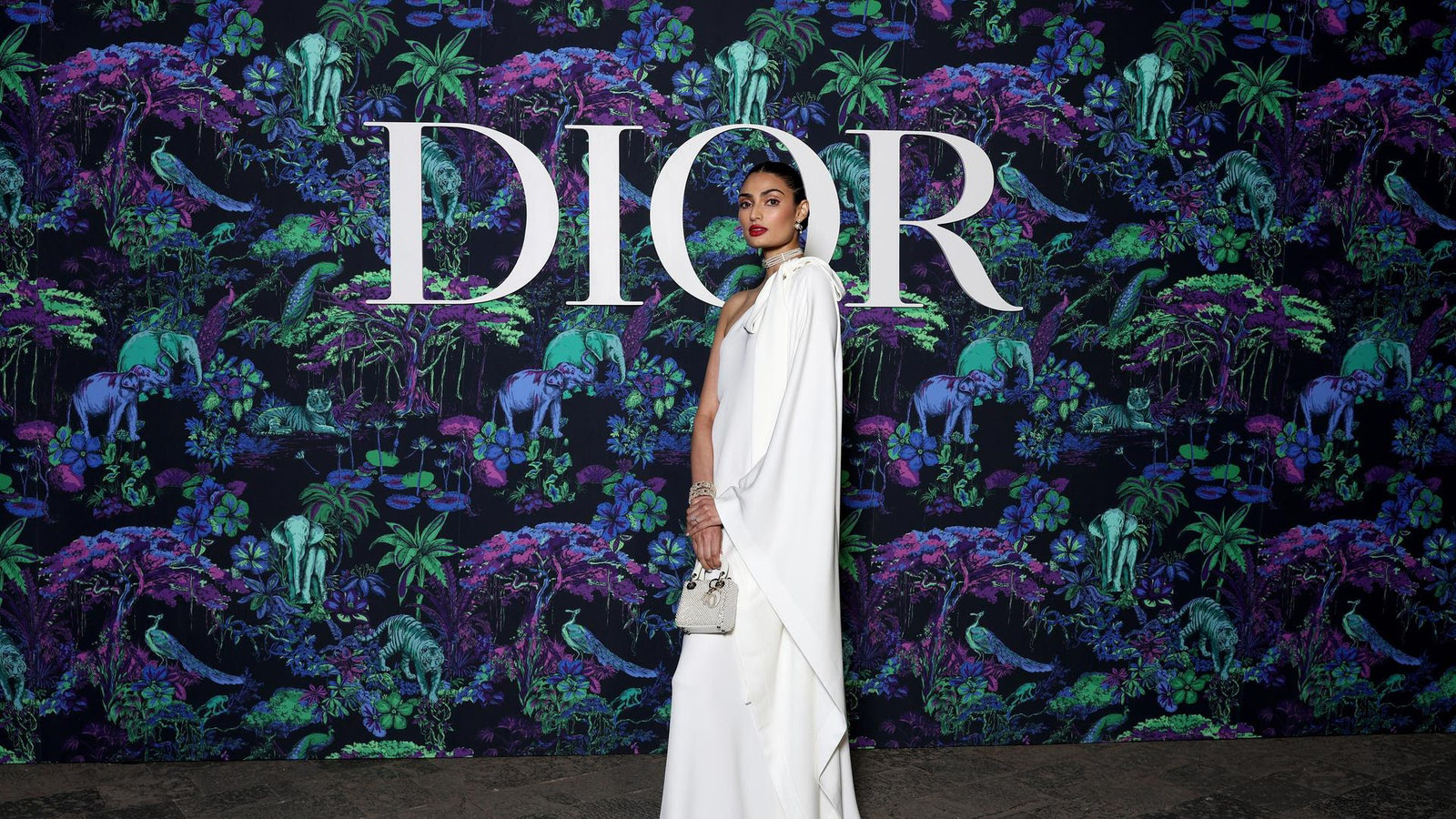 Dior Fall/Winter 2023 Show In Mumbai Athiya Shetty wore a Dior Pre Fall 2023 white silk dress with a Dior bag and shoes.