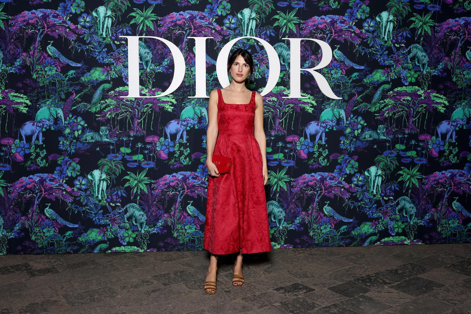 Dior Fall/Winter 2023 Show In Mumbai Jeanne Damas wore a Dior red silk brocade dress. She also wore a Dior bag and shoes