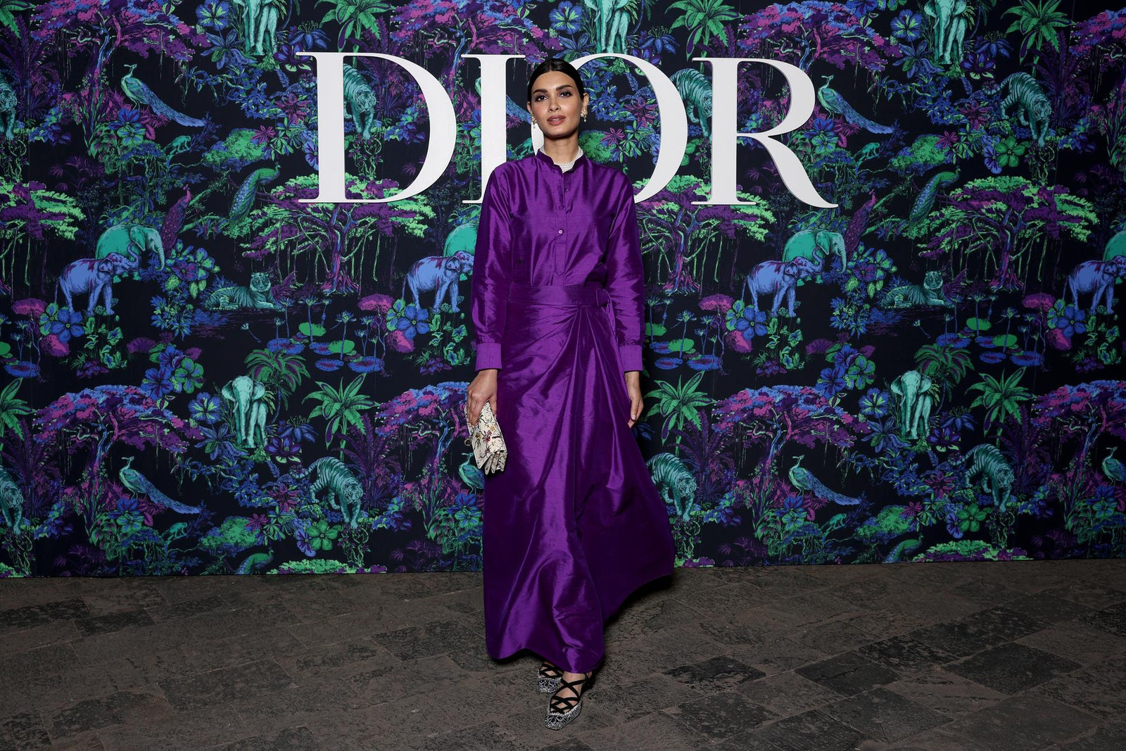 Dior Fall/Winter 2023 Show In Mumbai Diana Penty wore a Dior Pre Fall 2023 purple silk shirt and skirt with a Dior bag and shoes.