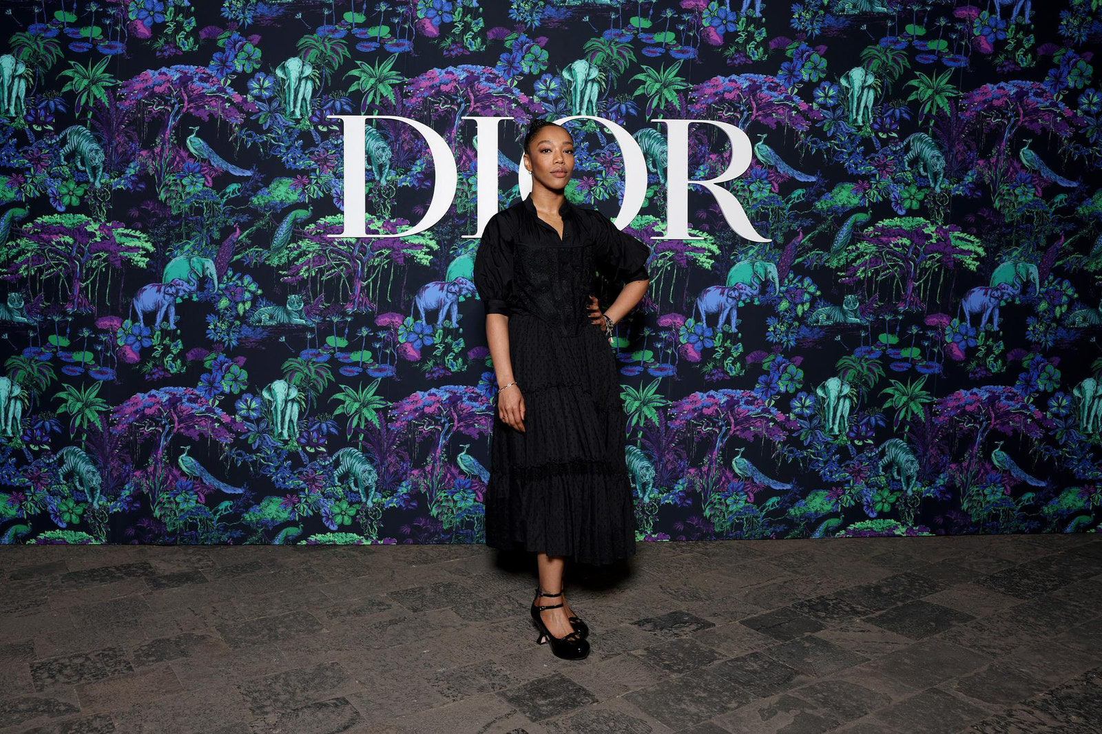 Dior Fall/Winter 2023 Show In Mumbai Naomi Ackie wore a Dior Spring-Summer 2023 black cotton shirt and skirt with a black lace bustier.