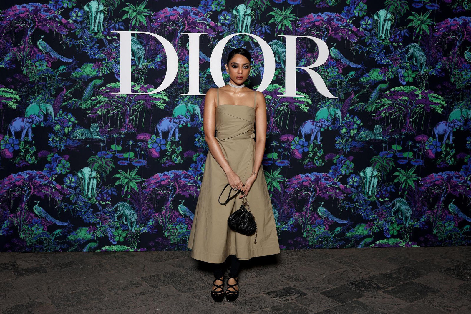 Dior Fall/Winter 2023 Show In Mumbai Sobhita Dhulipala wore a Dior Pre Fall 2023 beige silk dress with a Dior bag and shoes.