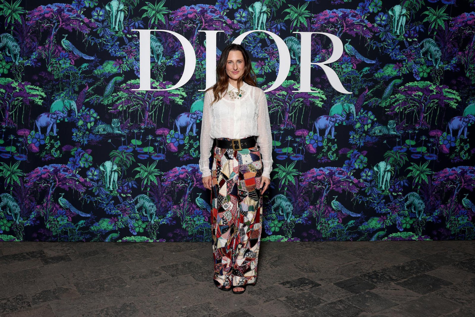 Dior Fall/Winter 2023 Show In Mumbai Camille Cottin wore a Dior white tulle shirt with multicolor patchwork pants.