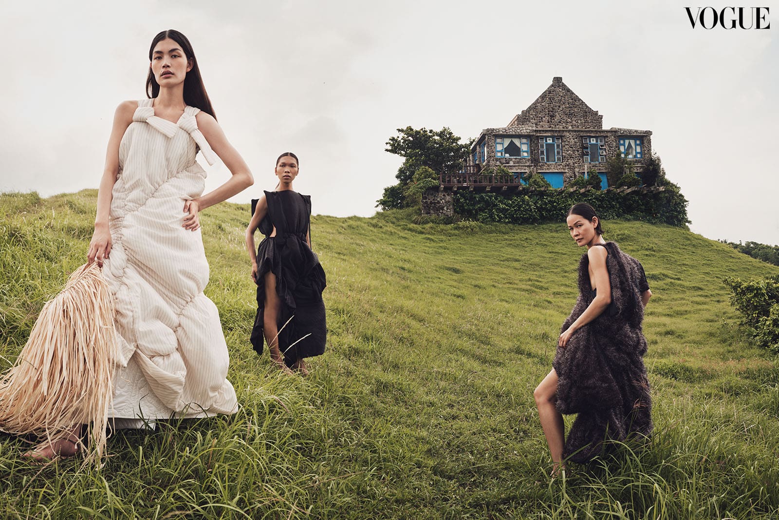 Rina, Lukresia, and Jo Ann wear NOVEL deconstructed puffer dresses molded from deadstock fabric to complement the female form through ruching and quilting manipulations, MELITTA BAUMEISTER white quilt skirt. All wear Ivatan Tukap rope sandals.