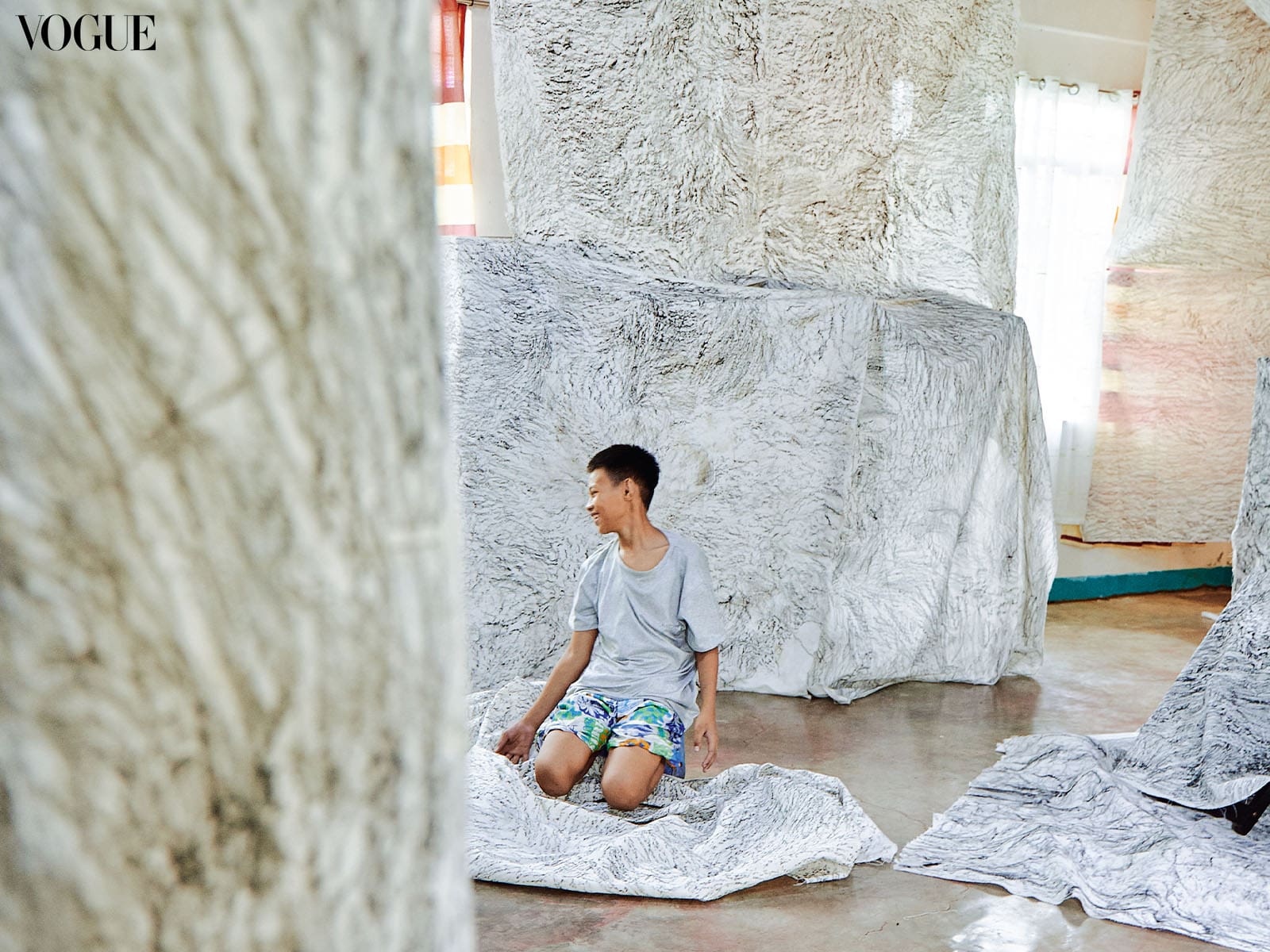 A Daraetan Elementary School student surveys his group’s creations: the precious rockscapes along Tinipak River, recreated in charcoal rubbings.