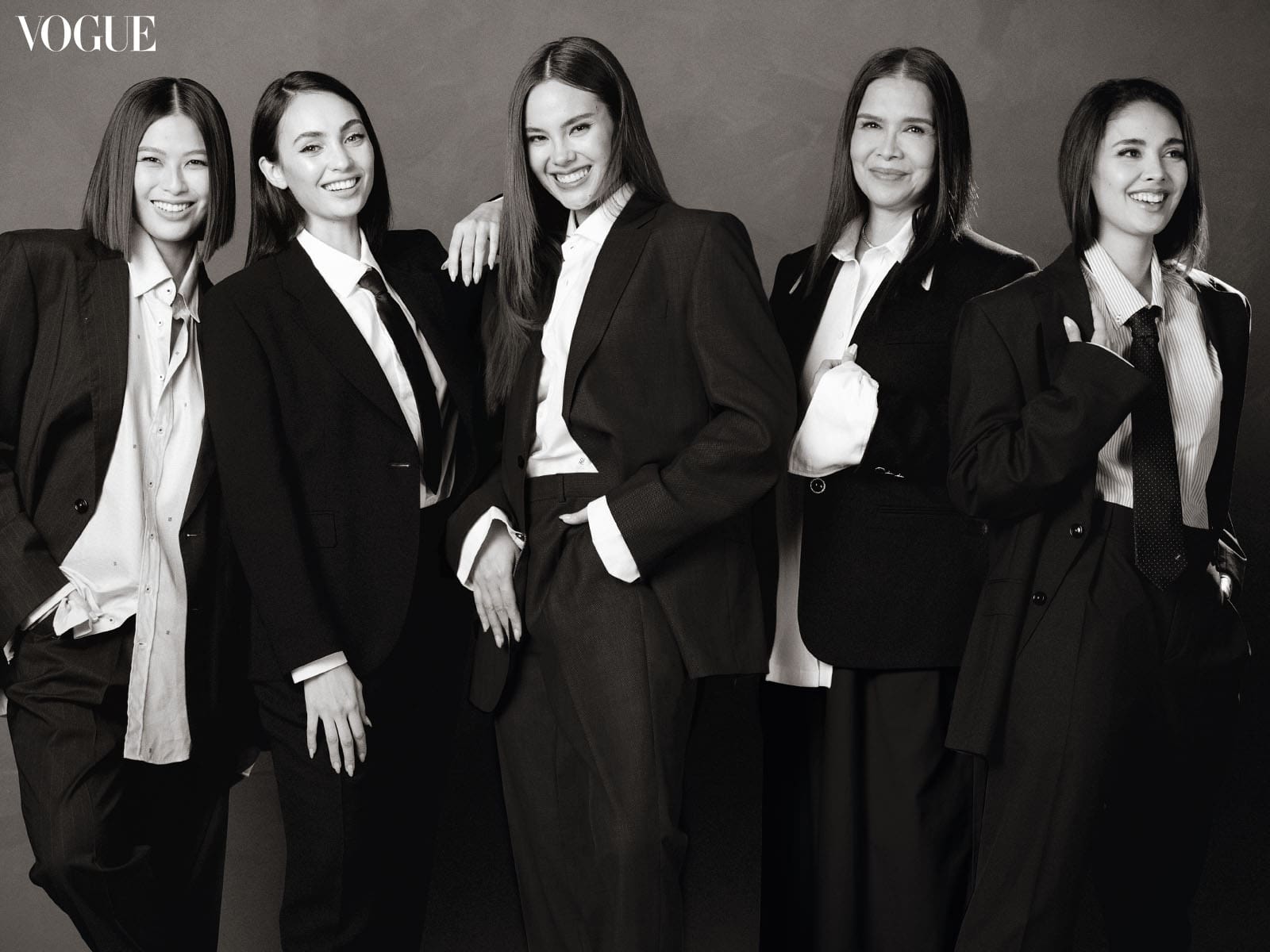 Megan Young, Melanie Marquez, Catriona Gray, R'Bonney Gabriel, and Michelle Dee smiling in black and white suits