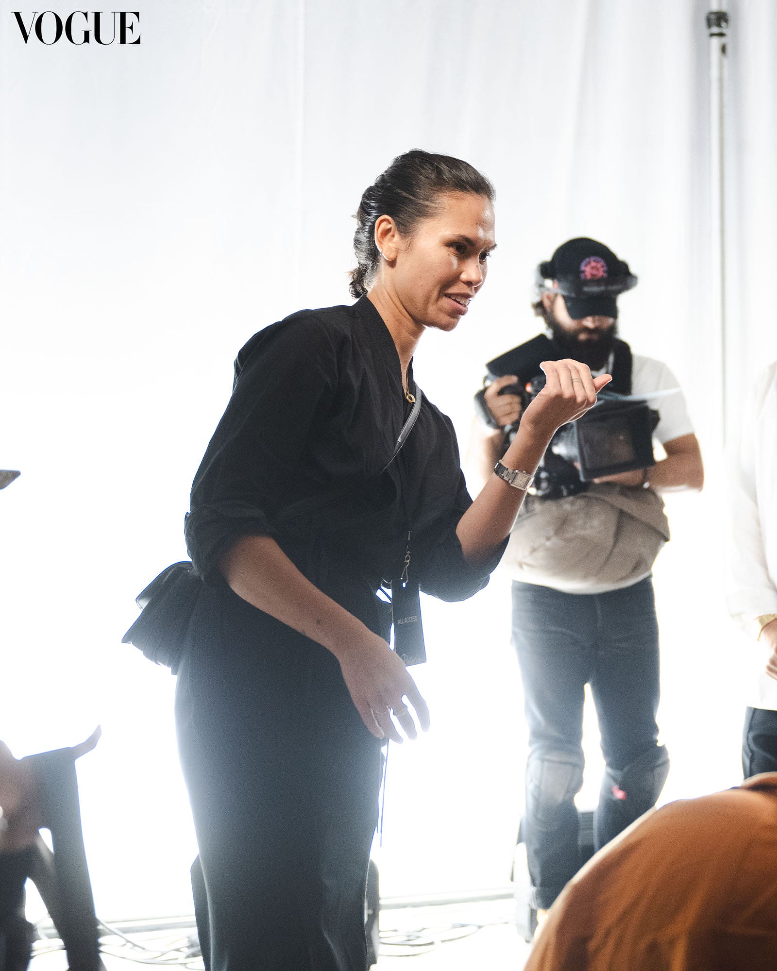 Melissa Levy wearing a black button down shirt directing a photoshoot