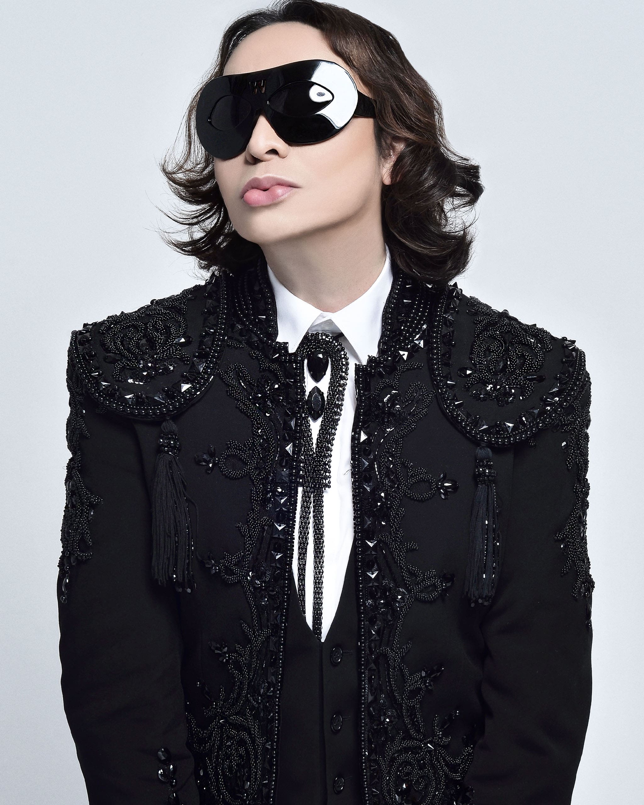 Michael Cinco wearing black oversized glasses in beaded black blazer