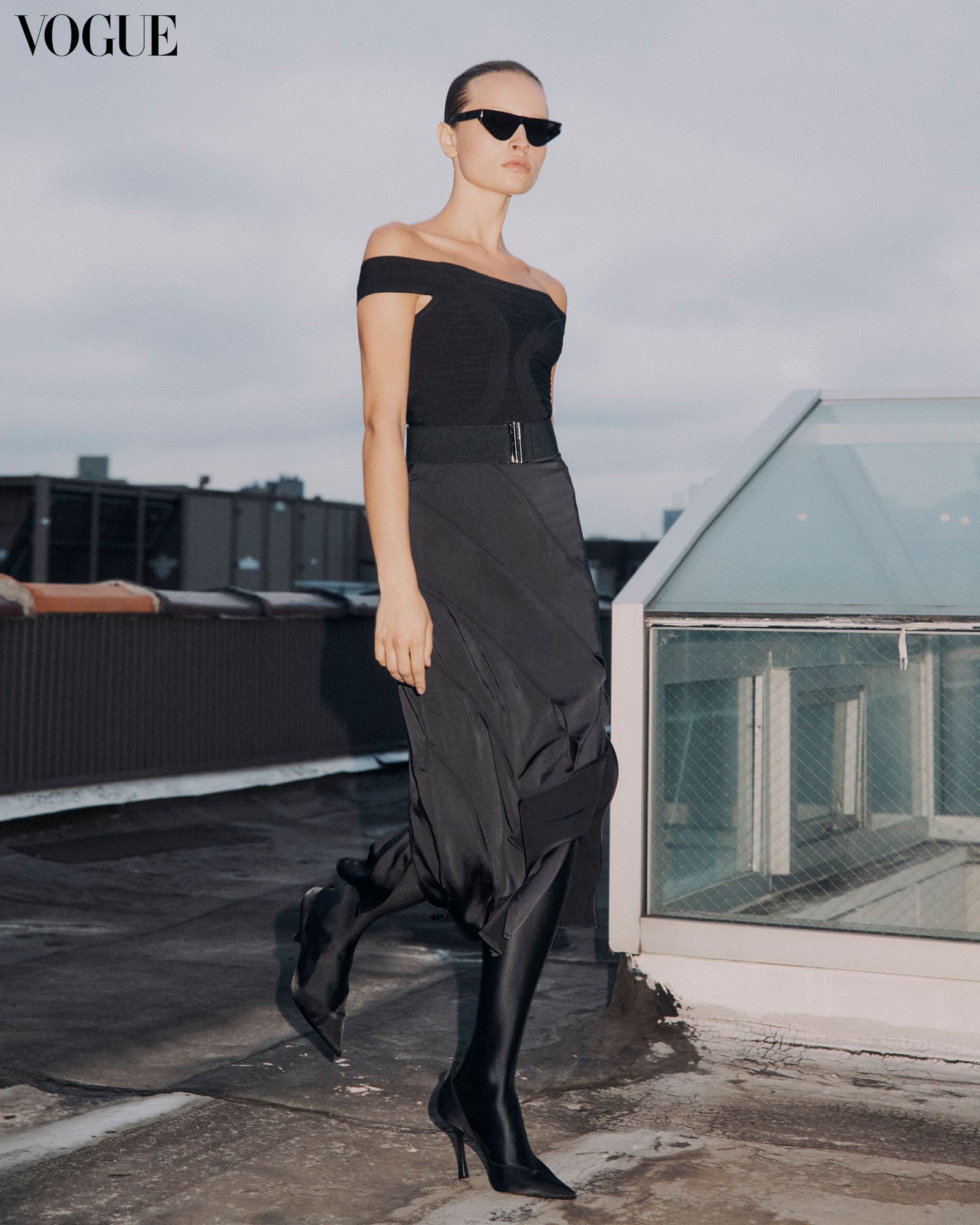 girl wearing Michelle Ochs black bondage dress and black heel boots