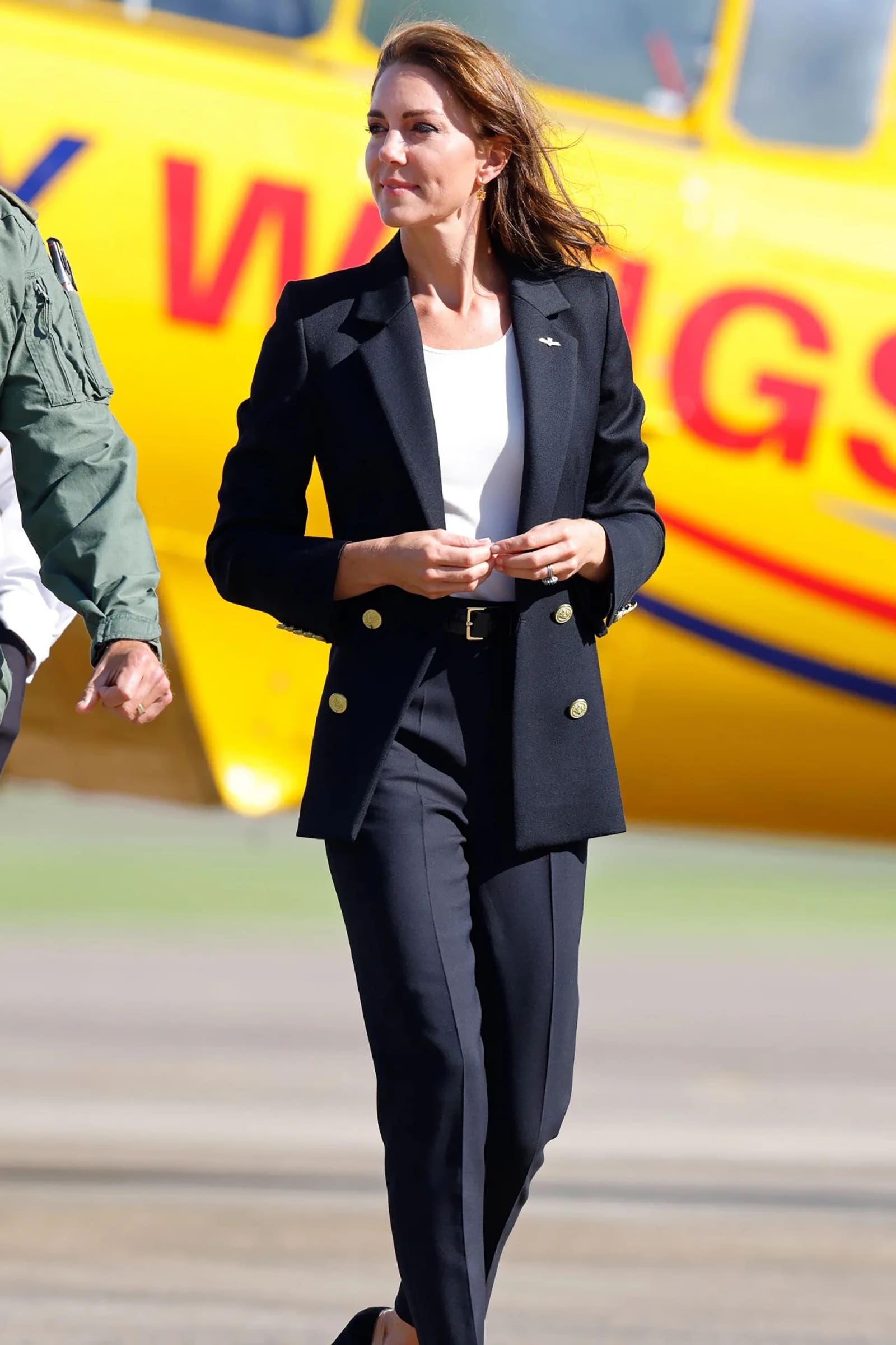 Princess Kate in a black suit and pants.