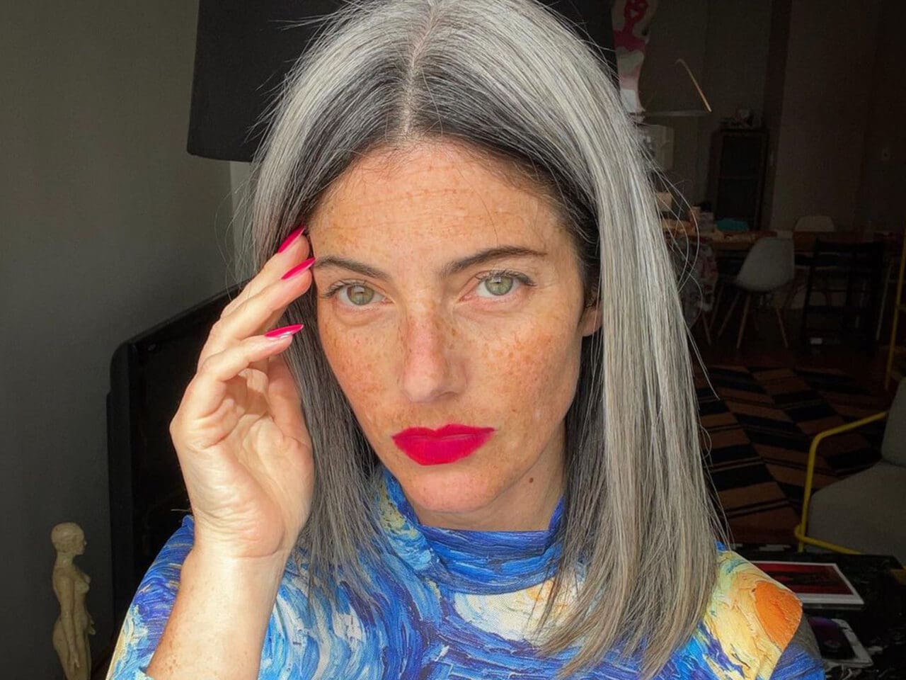 A woman with a Vincent Van Gogh top and grey hair