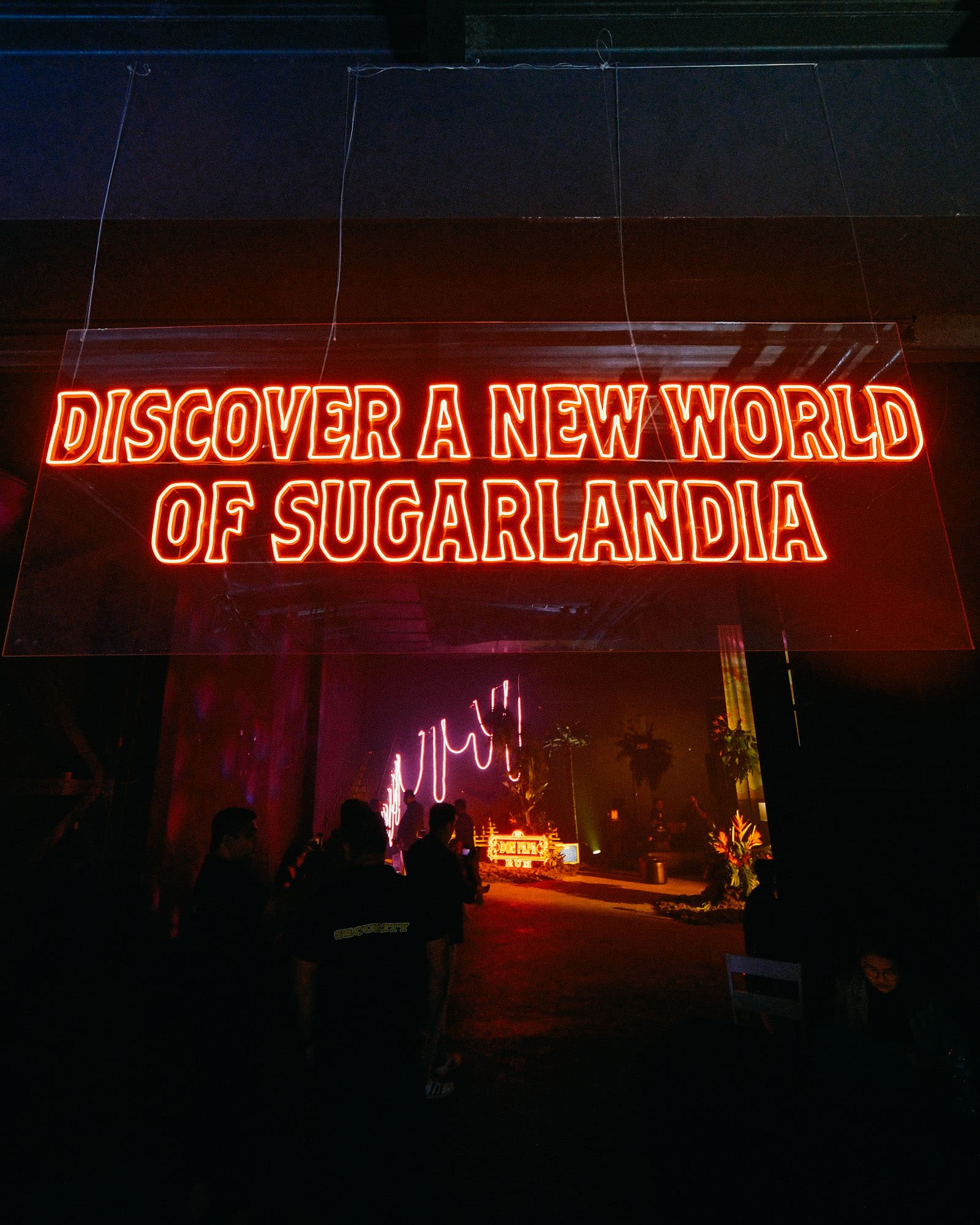 A red LED sign that says Discover a New World of Sugarlandia