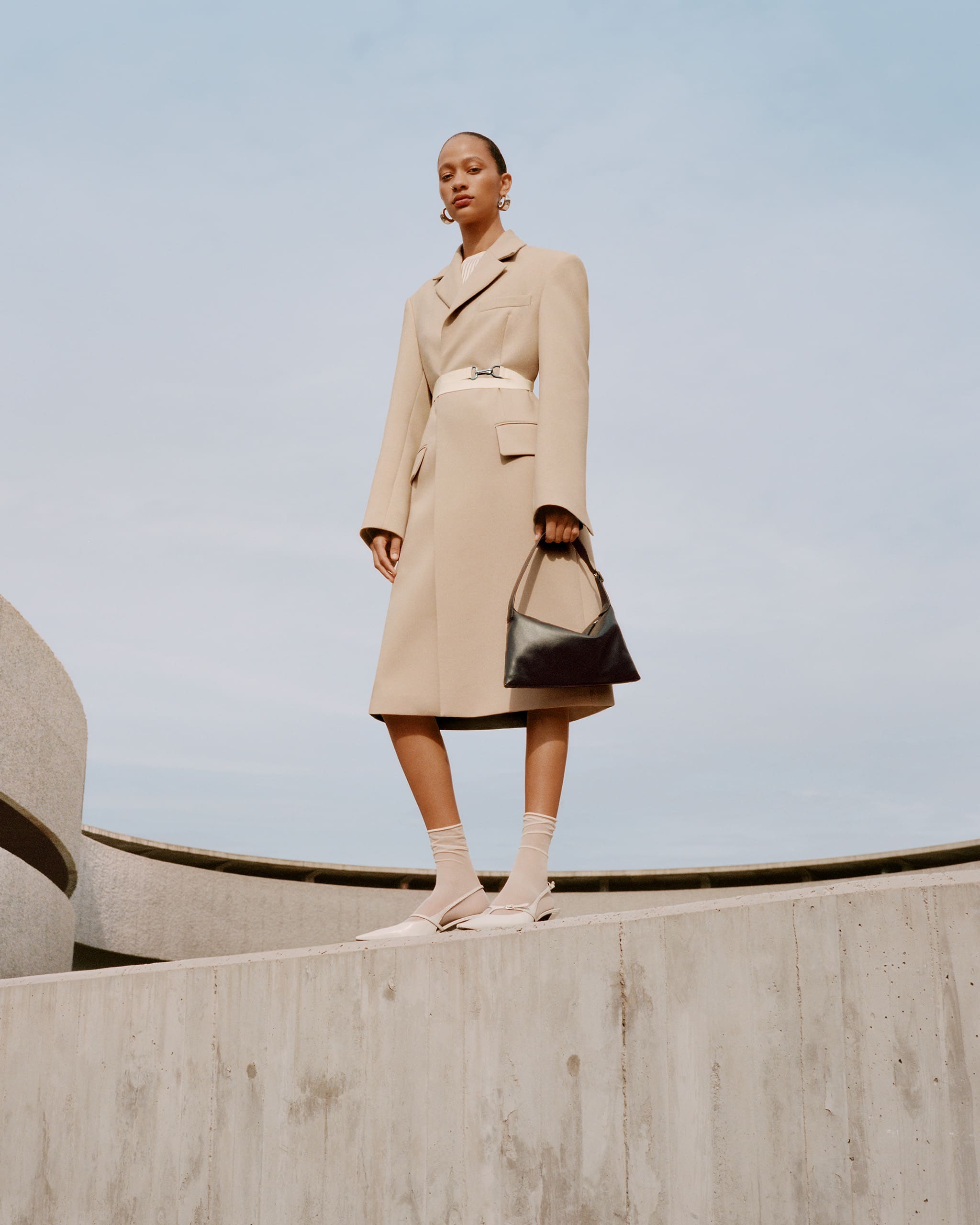 Selena Forrest wearing a beige trench coat from Mango's Selection collection