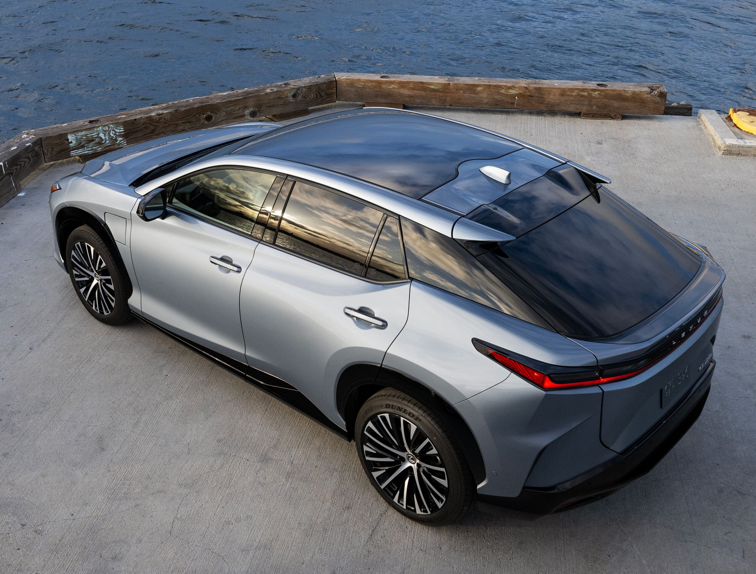 panoramic sun roof | vogue philippines The silver gray Lexus RZ parked by a port
