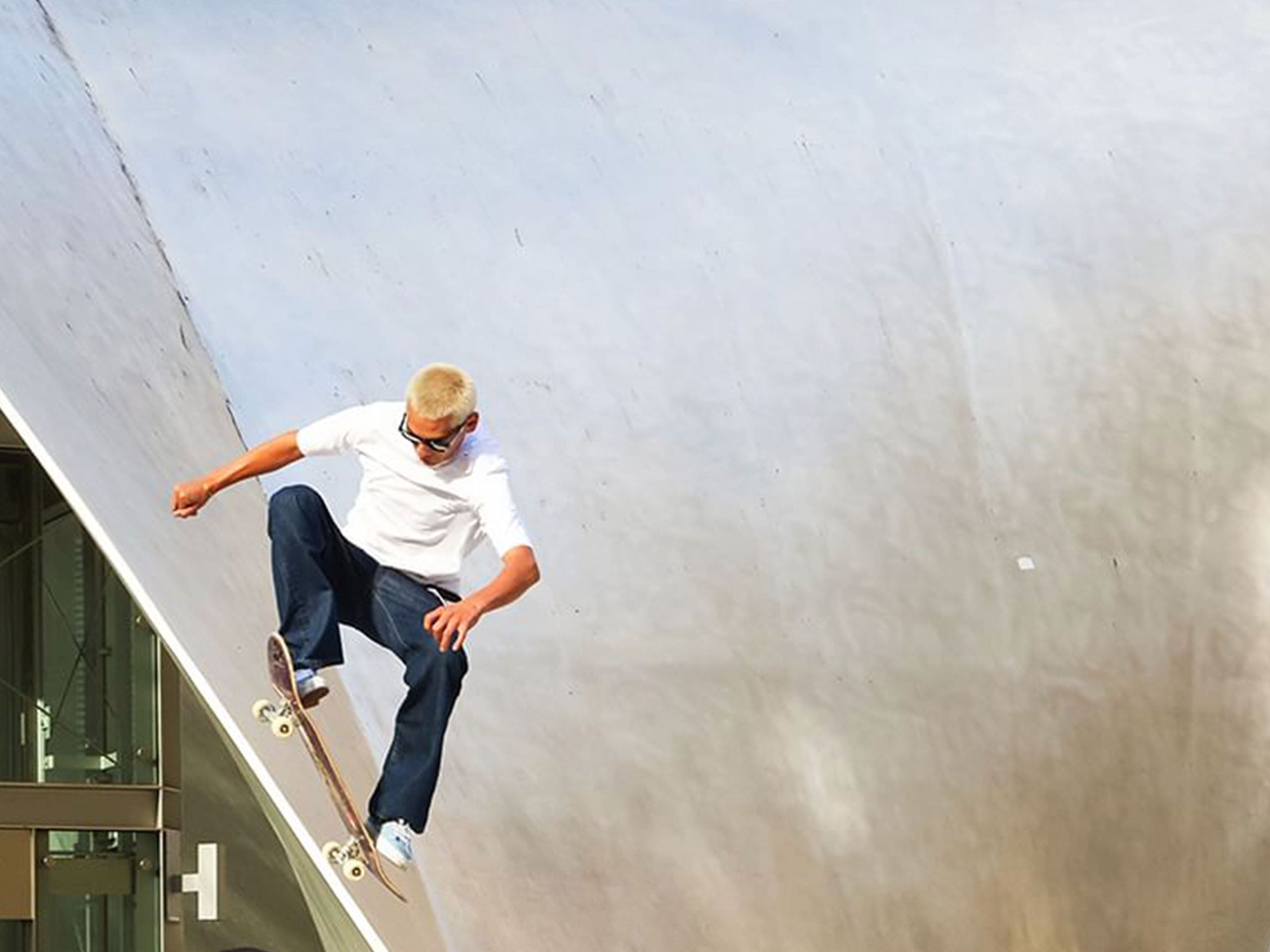 Evan Mock skateboarding wearing black Maui Jim sunglasses