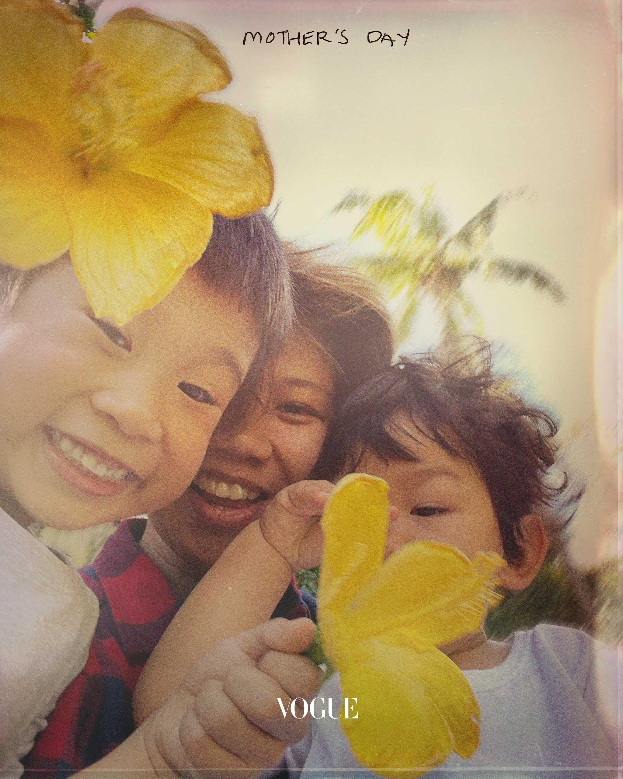 Alee Garibay with her two male children holding yellow flowers