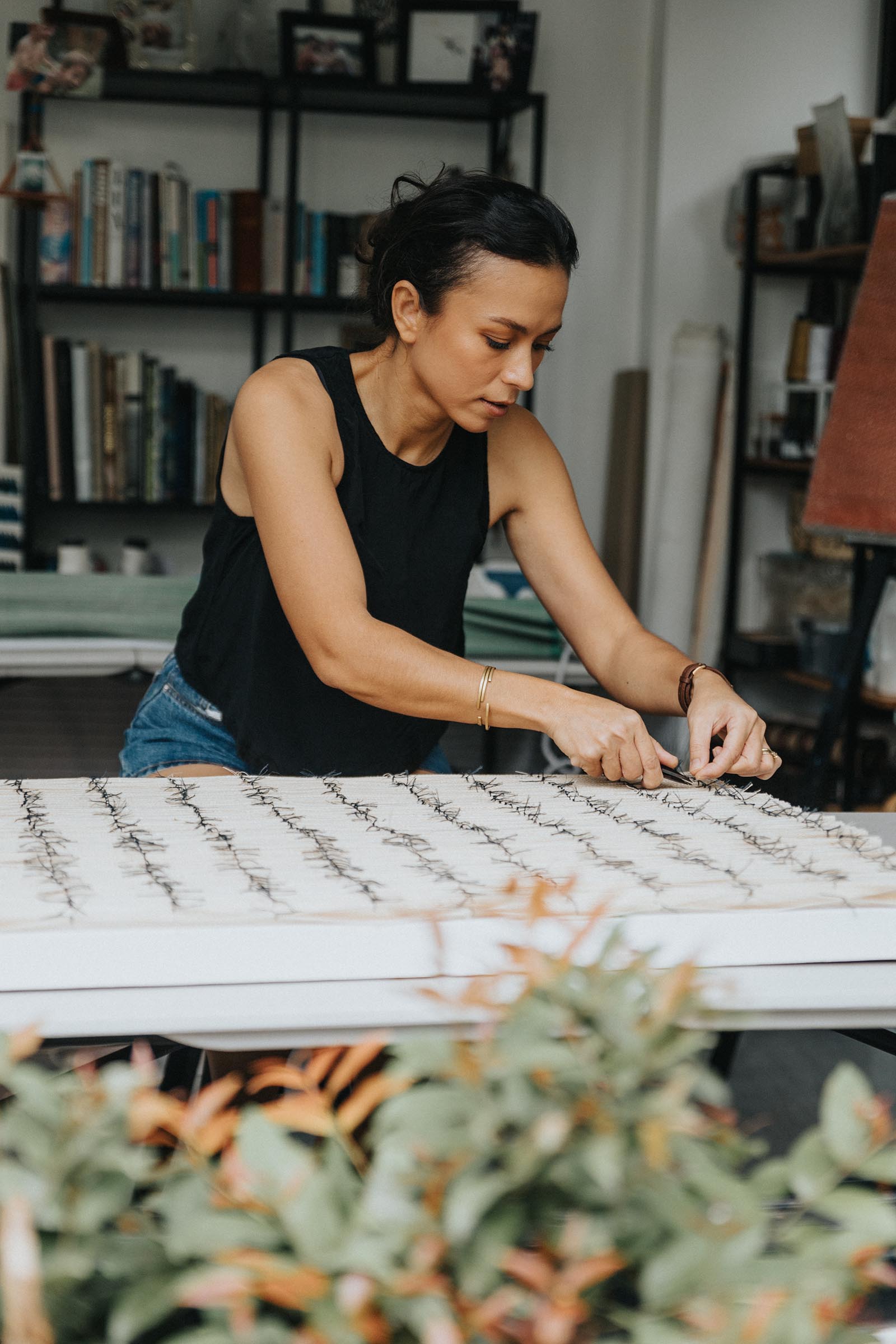 Photo of Olivia d'Aboville working on her textile painting.