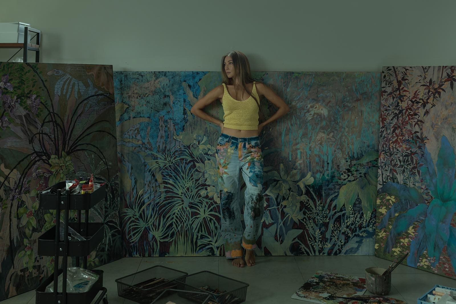 Artist Solenn Heusaff posed in front of her paintings.