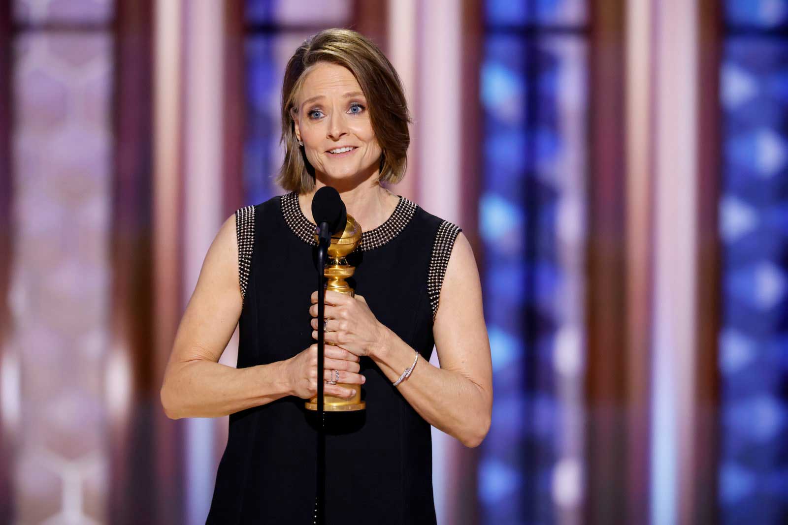 Actress Jodie Foster delivers a speech onstage with her Golden Globe after winning the award for True Detective: Night Country.