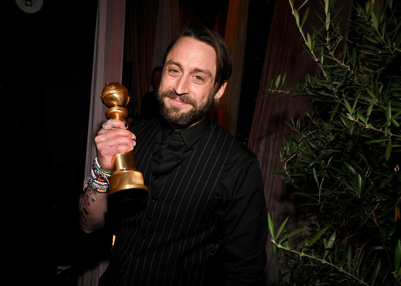 Actor Kieran Culkin holding his Golden Globe after winning the award for 