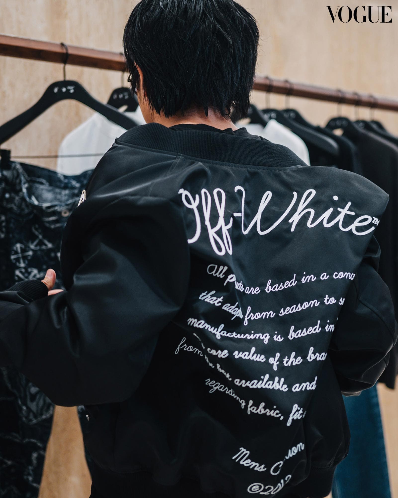Danyl Geneciran trying on the Off-White OW Varsity Jacket in black.