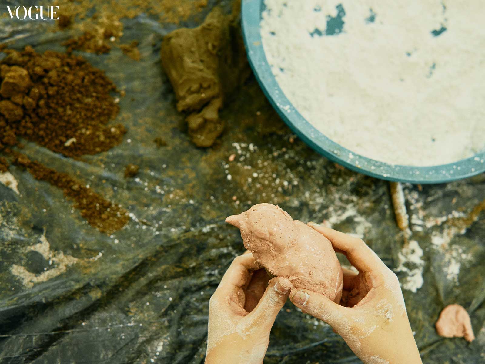 Closeup of hands molding clay.